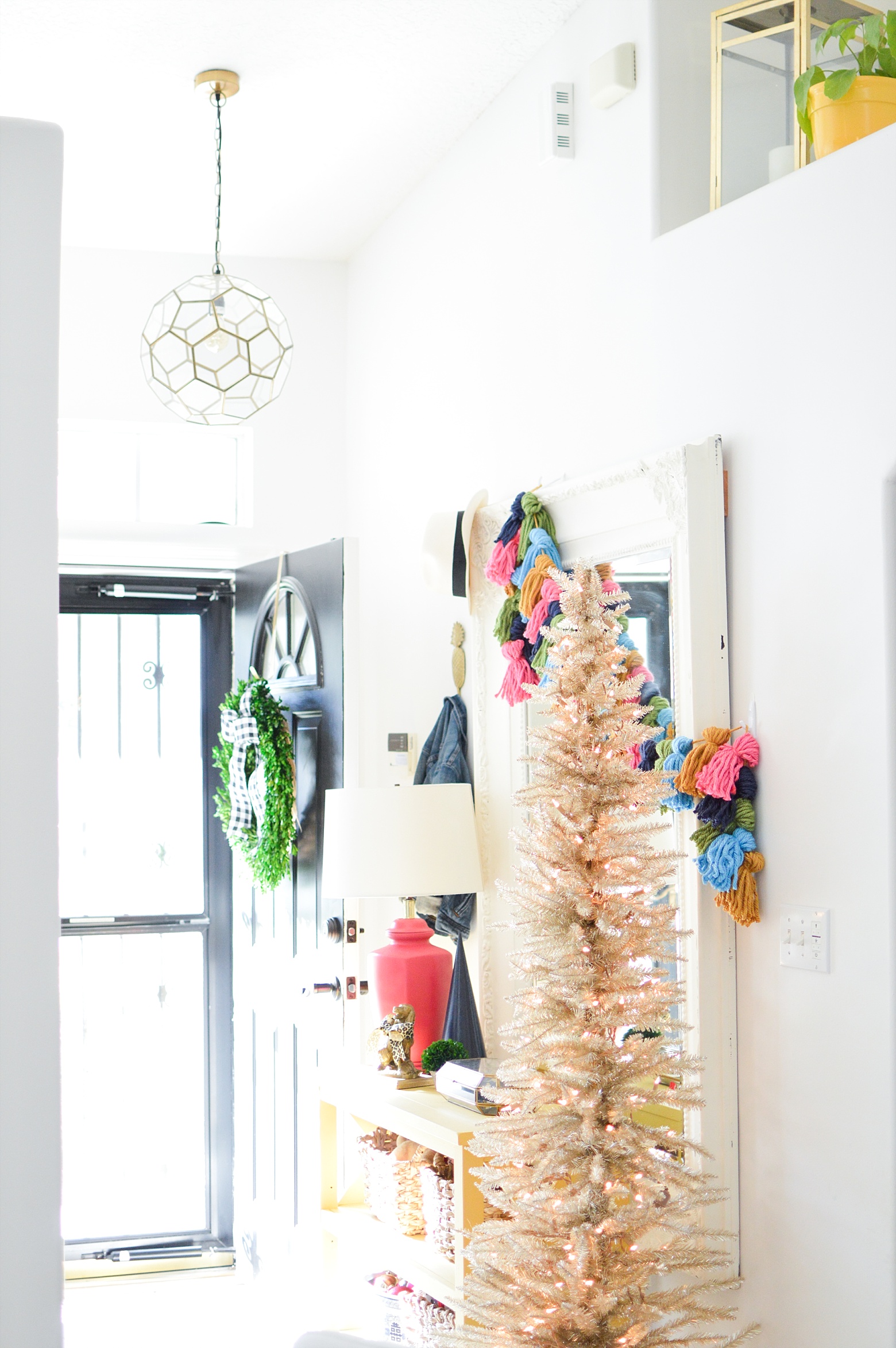 Christmas entry way, colorful holiday decorations, diy tassel garland, bright holiday on Megan Martin Creative