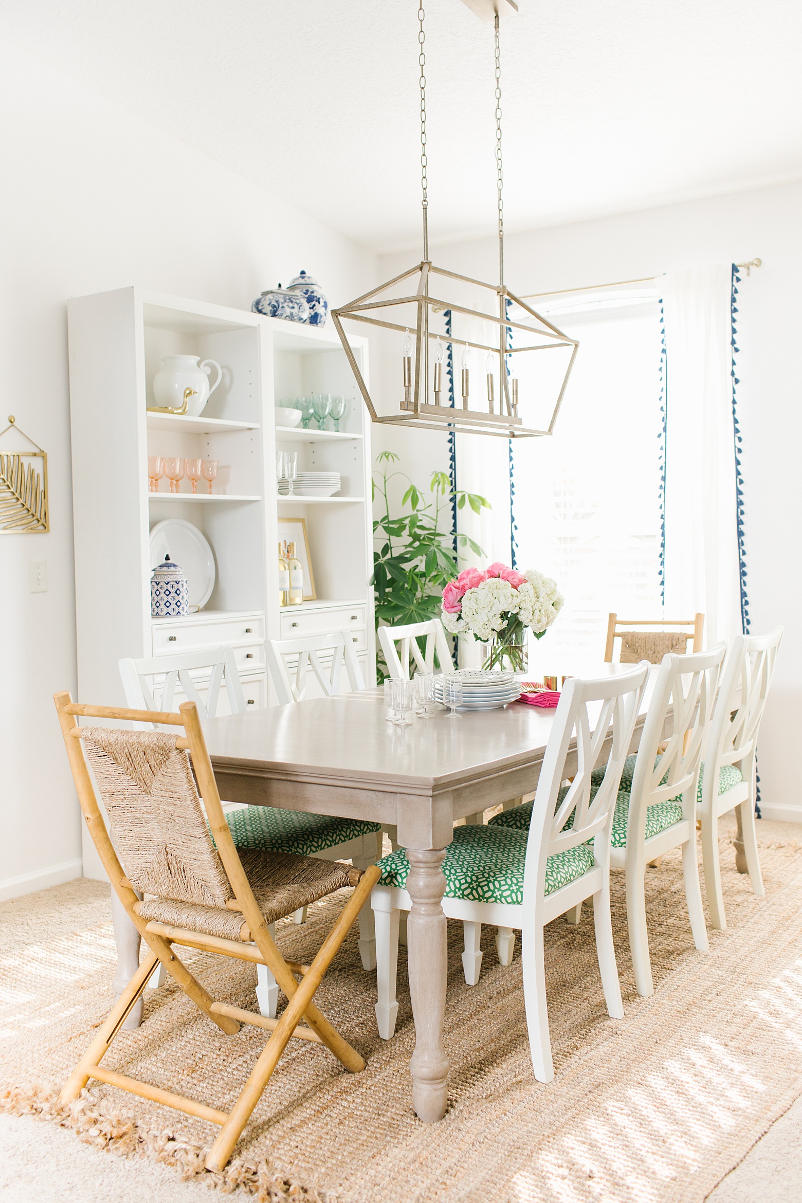 Bright Florida Colorful Dining Room, brass lantern light fixture, restoration hardware shelves, jute rug, family friendly dining room, white walls, bamboo dining chairs, design by Megan Martin Creative