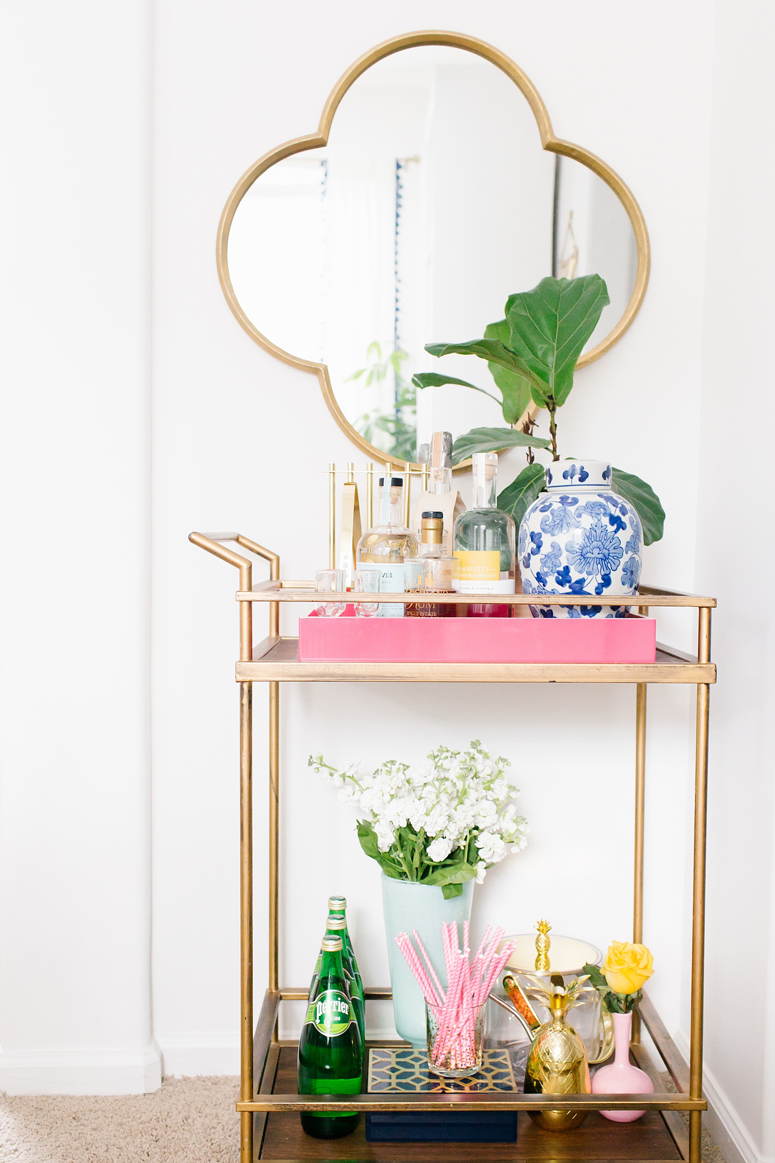 Colorful Bar Cart decor in this colorful dining room tour on Megan Martin Creative. Target bar cart, quatrefoil mirror, fiddle fig plant, chinoiserie, white walls, bright home decor, colorful home