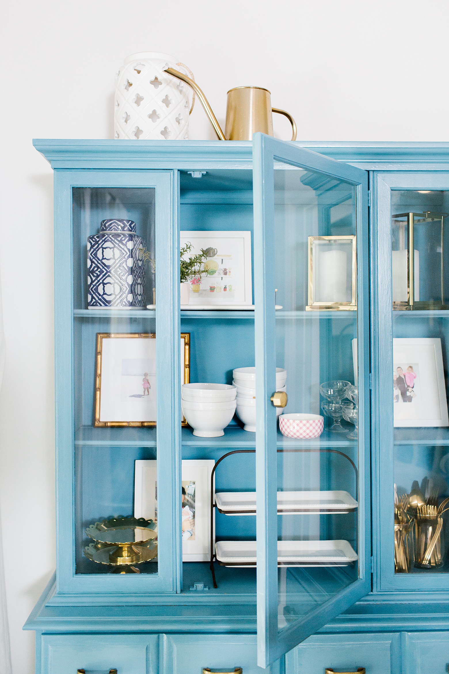 designer tips to decorating with color and pattern in your home on Megan Martin Creative, A vintage hutch in blue! Chalk paint, Amy Howard Home Rugo, bright white kitchen, gold white and navy kitchen, anthropologie knobs