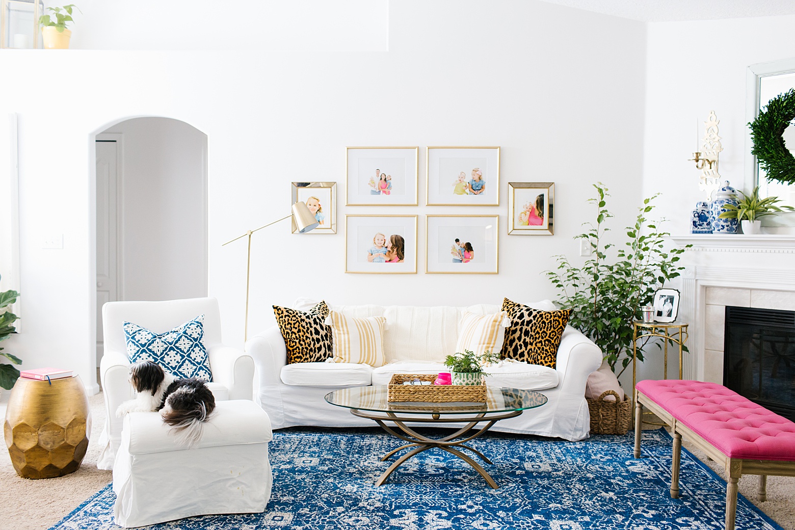 bright and colorful living room in navy, pink, green, mint and gold. navy and white rug, white sofa, open living room - designed by Megan Martin Creative