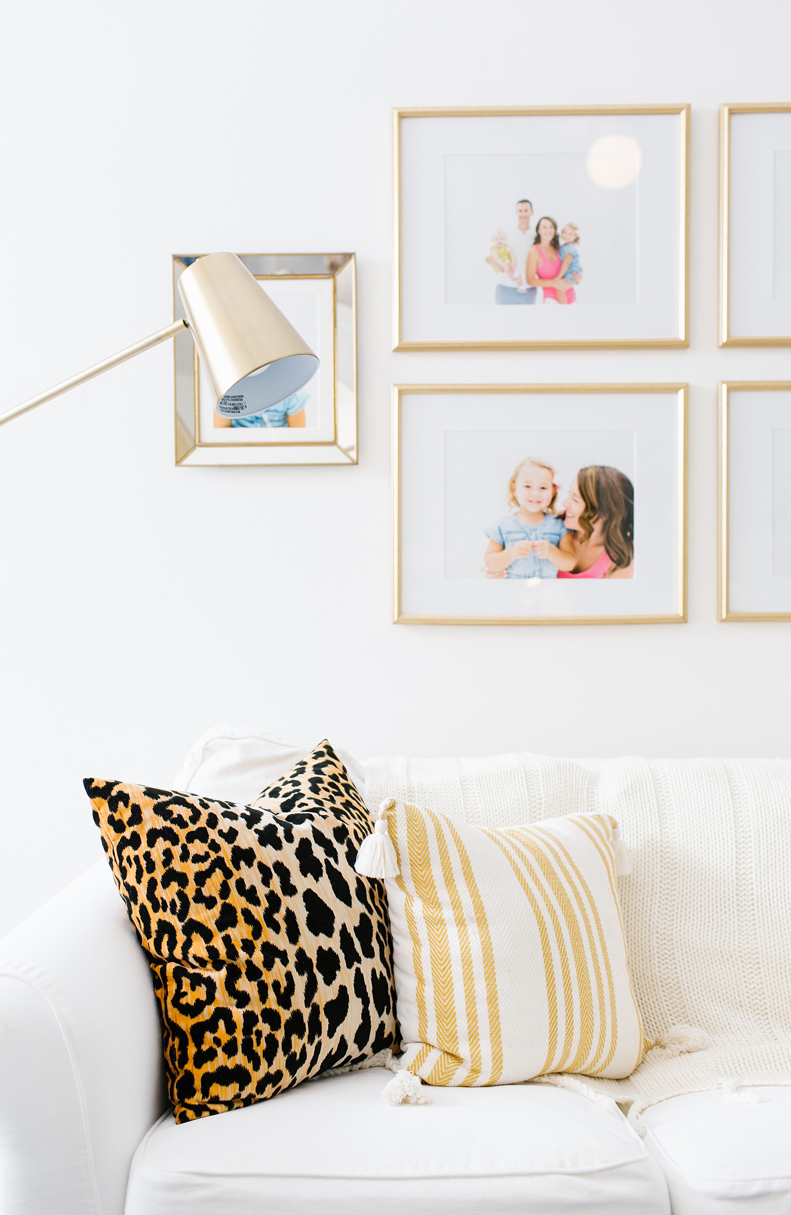 leopard pillow, striped pillow, family photo gallery wall, bright and colorful living room on Megan Martin Creative 