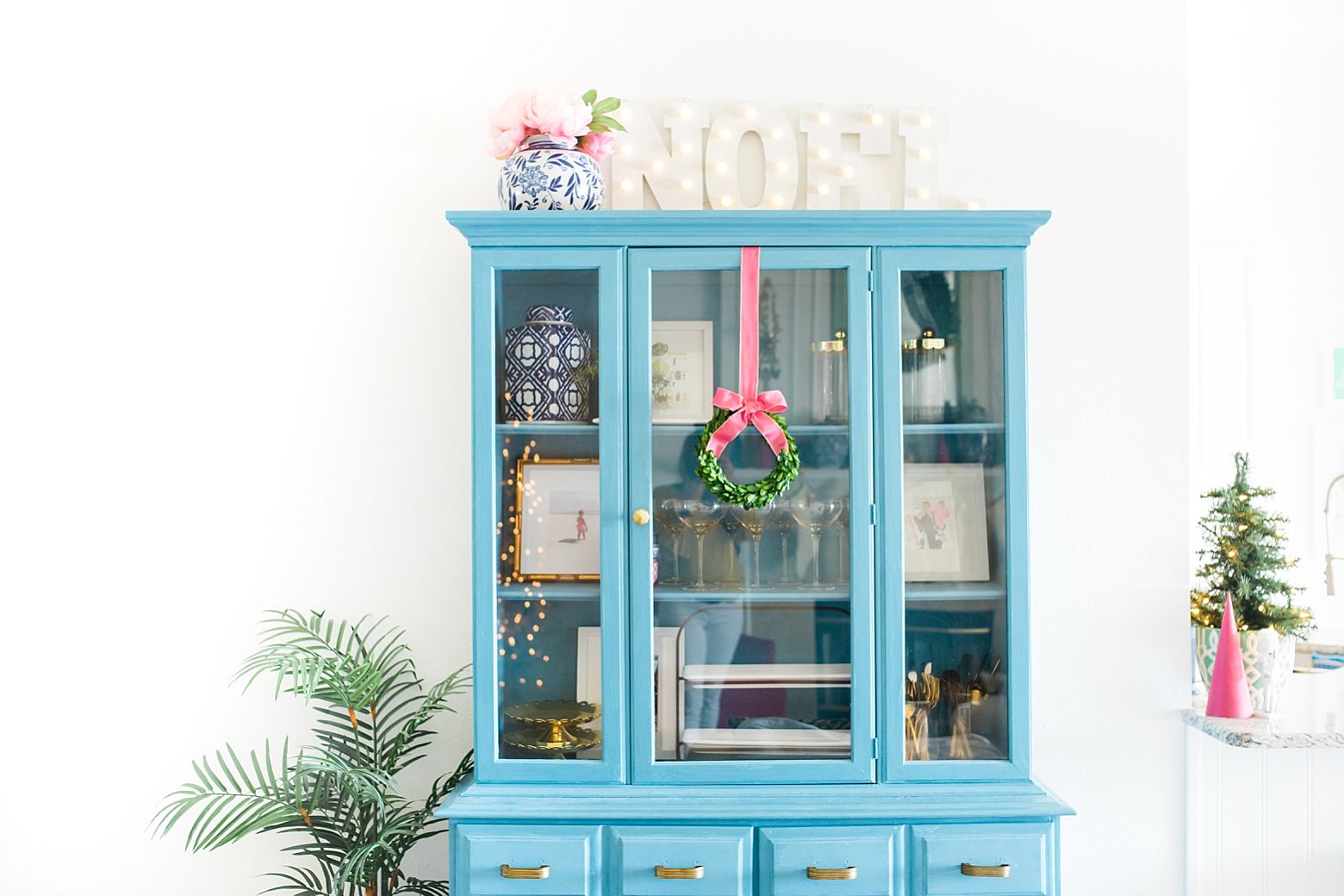 Blue hutch, colorful Christmas decorations, pink holiday